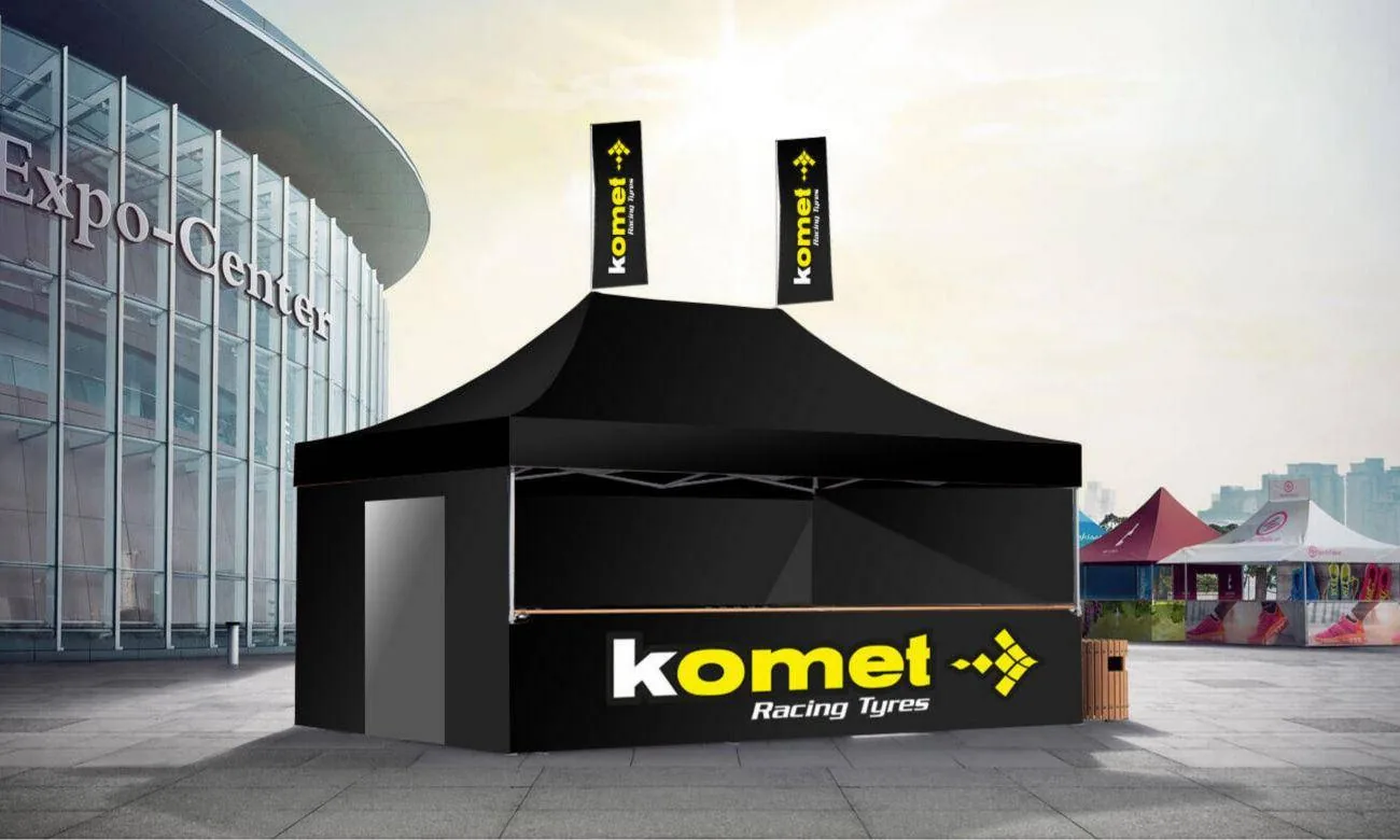 The black Komet Mastertent with yellow Komet branding and flags